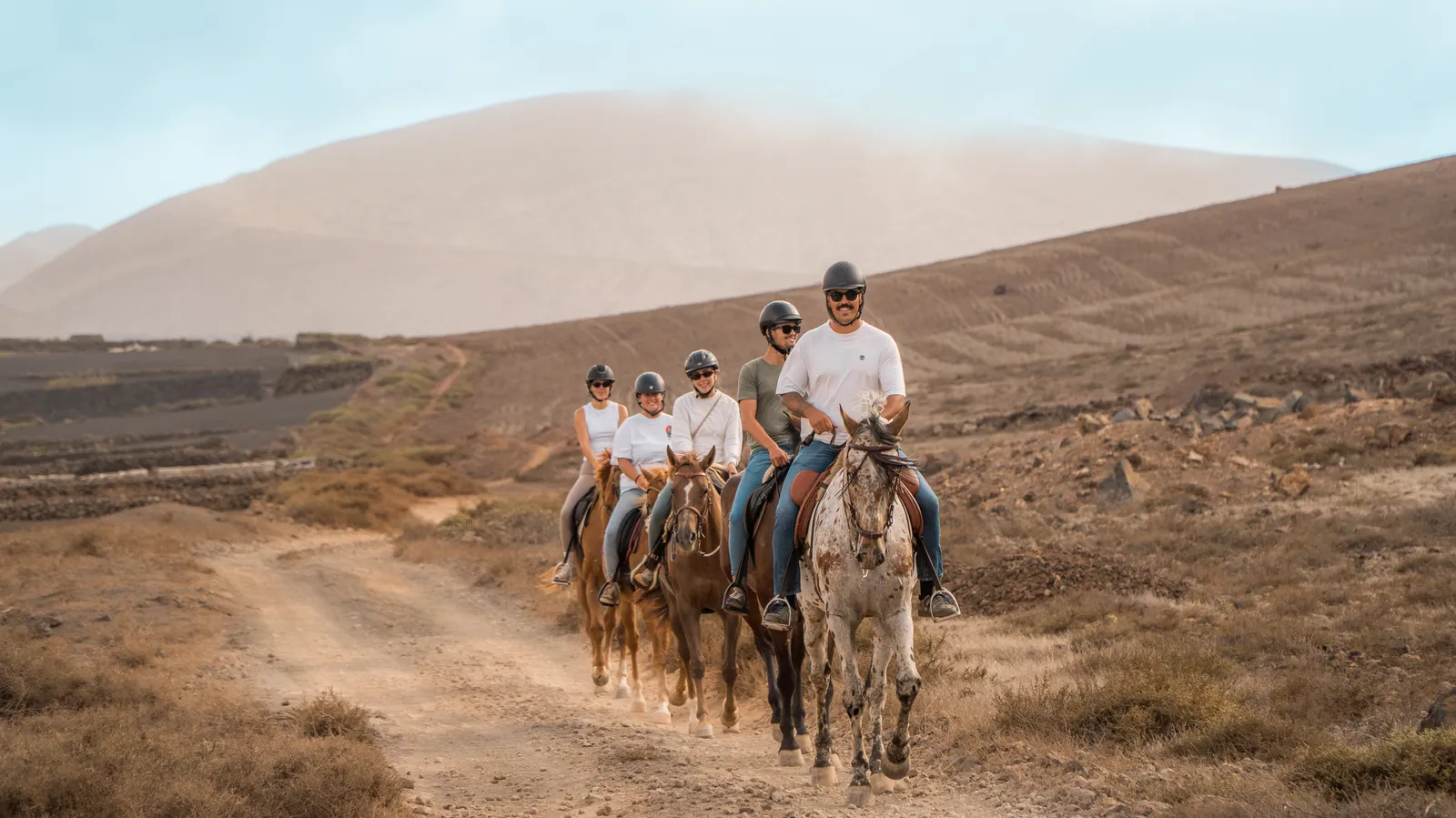 Riders crossing the volcanic landscape of Lanzarote